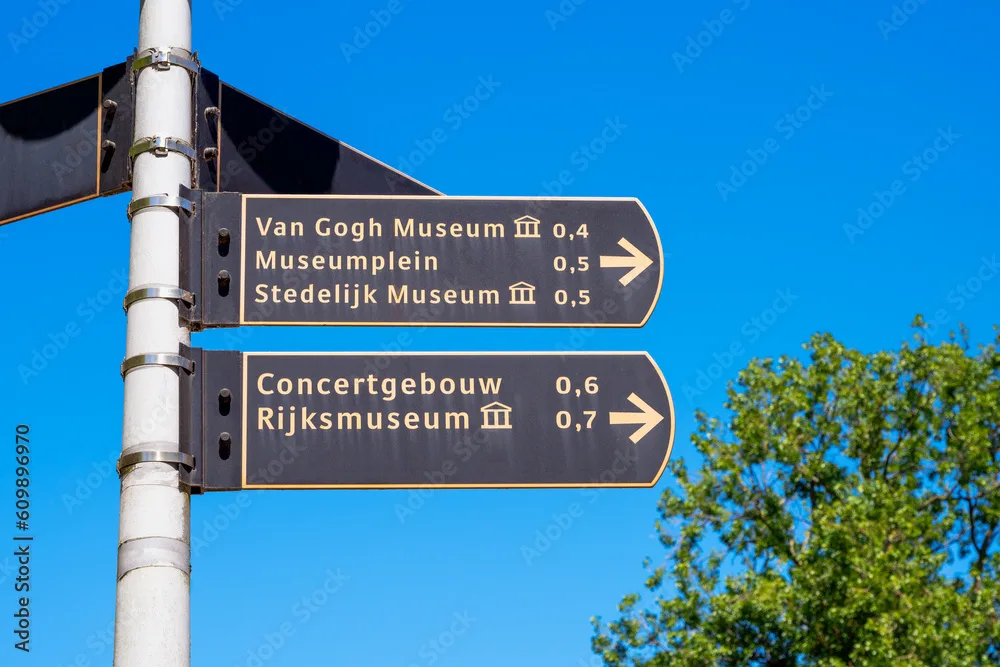 Directional Signs to Van Gogh, Rijks and Stedelijk Museum in Amsterdam, The Netherlands. The Concertgebouw is a Concert Hall. Museumplein means Museum Square.